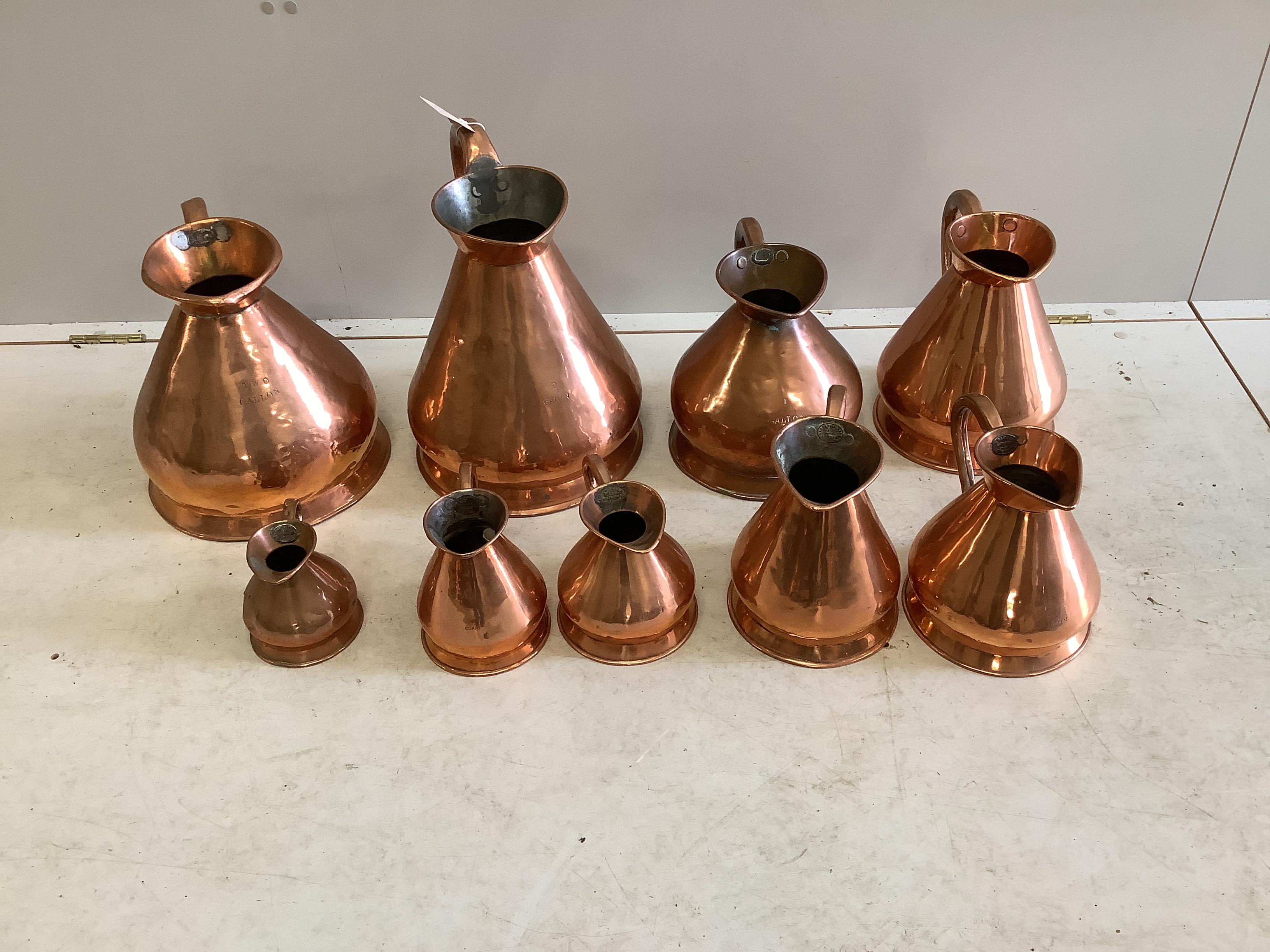 Nine 19th / early 20th century copper haystack measures, two gallons to one pint, largest height 38cm